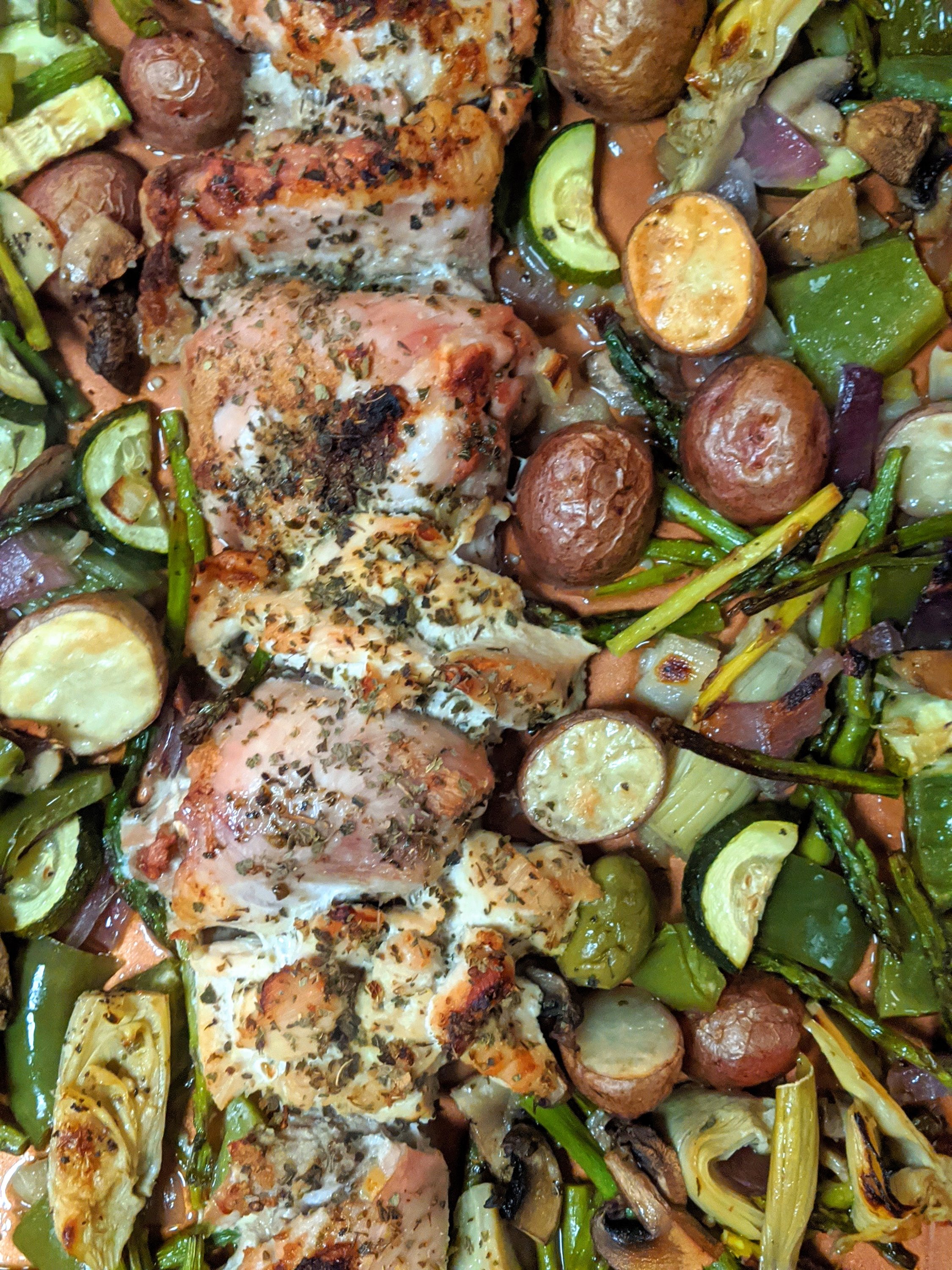 easy healthy sheet pan chicken thighs with potatoes zucchini peppers and onions in mediterranean spices