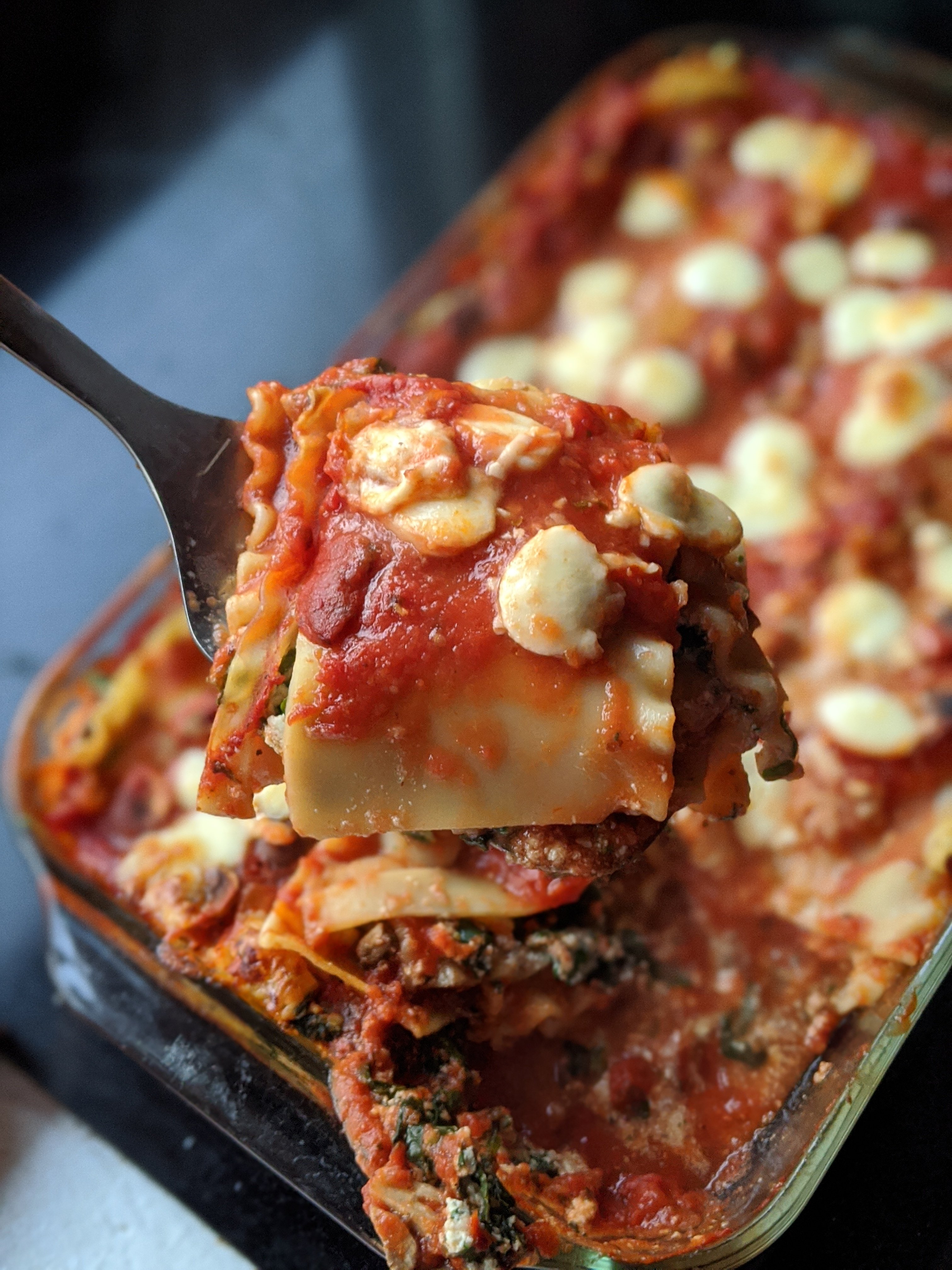 vegan lasagna with tofu and spinach mushrooms tomatoes and vegan mozzarella cheese
