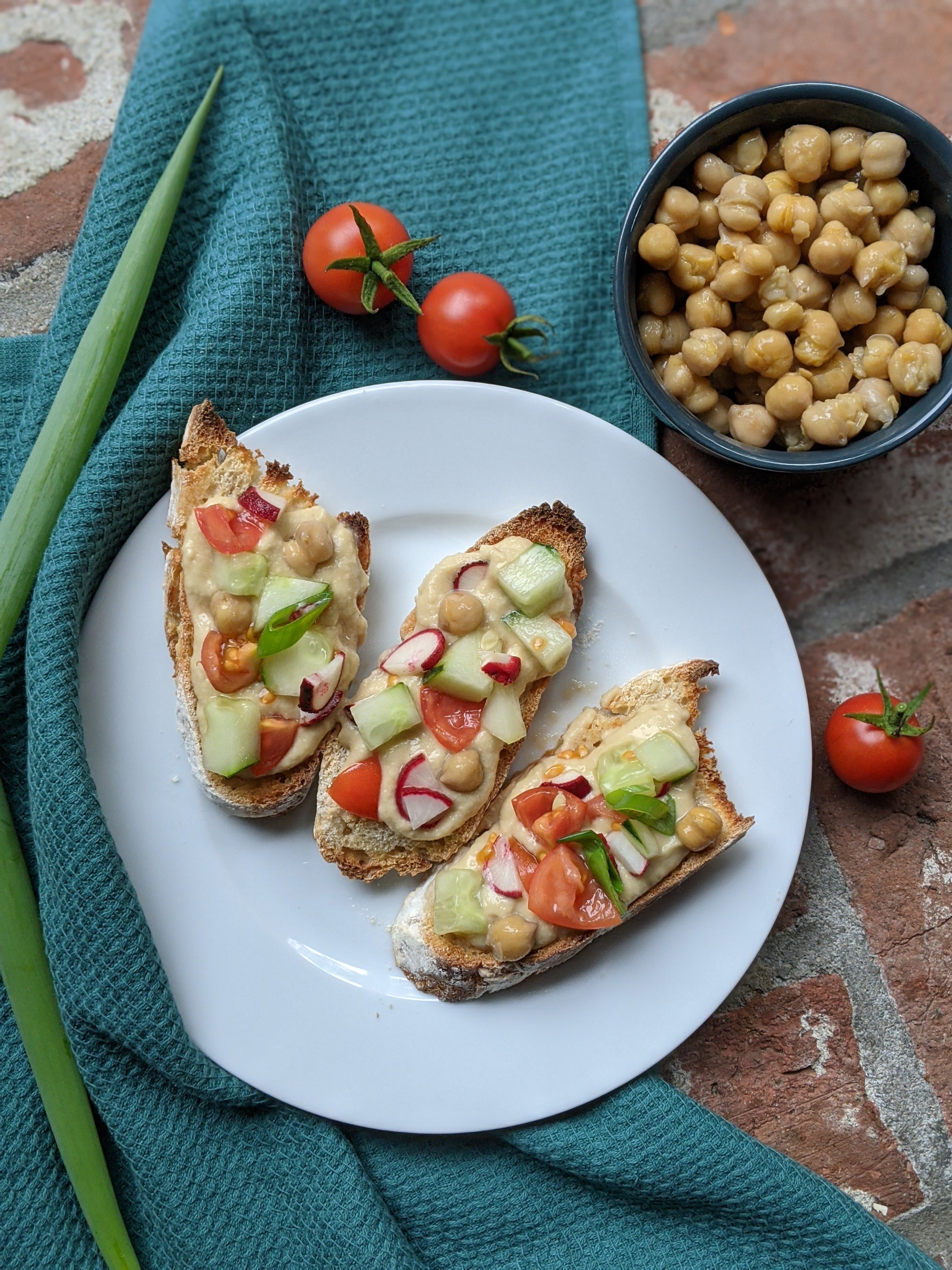 gluten free hummus toast recipe with fresh garden vegetables tomatoes chickpeas green onions cucumber recipes to use fresh tomatoes for breakfast snack healthy fresh snack ideas