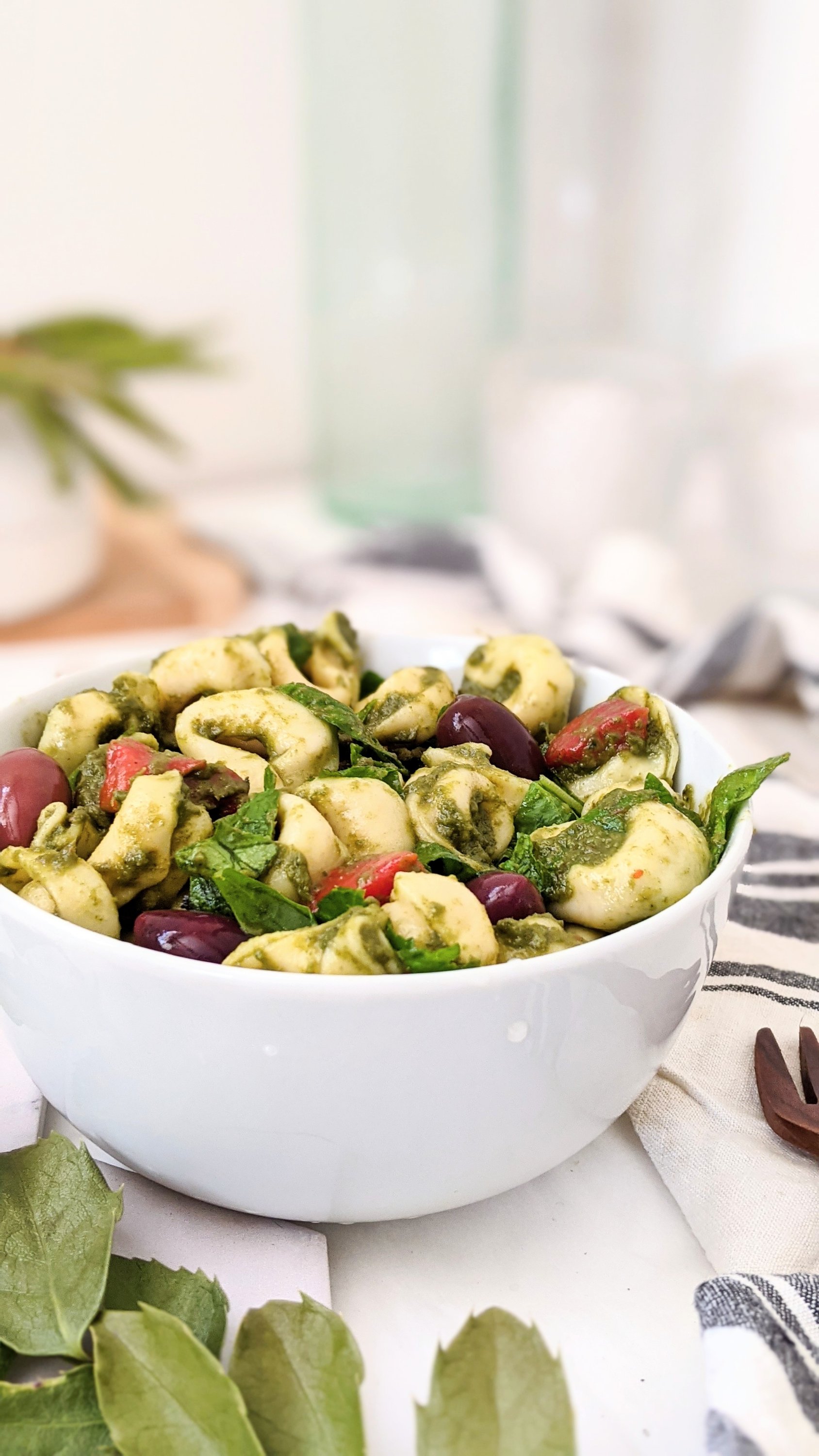 easy tortellini salad with cherry tomatoes healthy plant based pesto pasta salad with kalamata olives roasted red pepper and greek pesto dressing