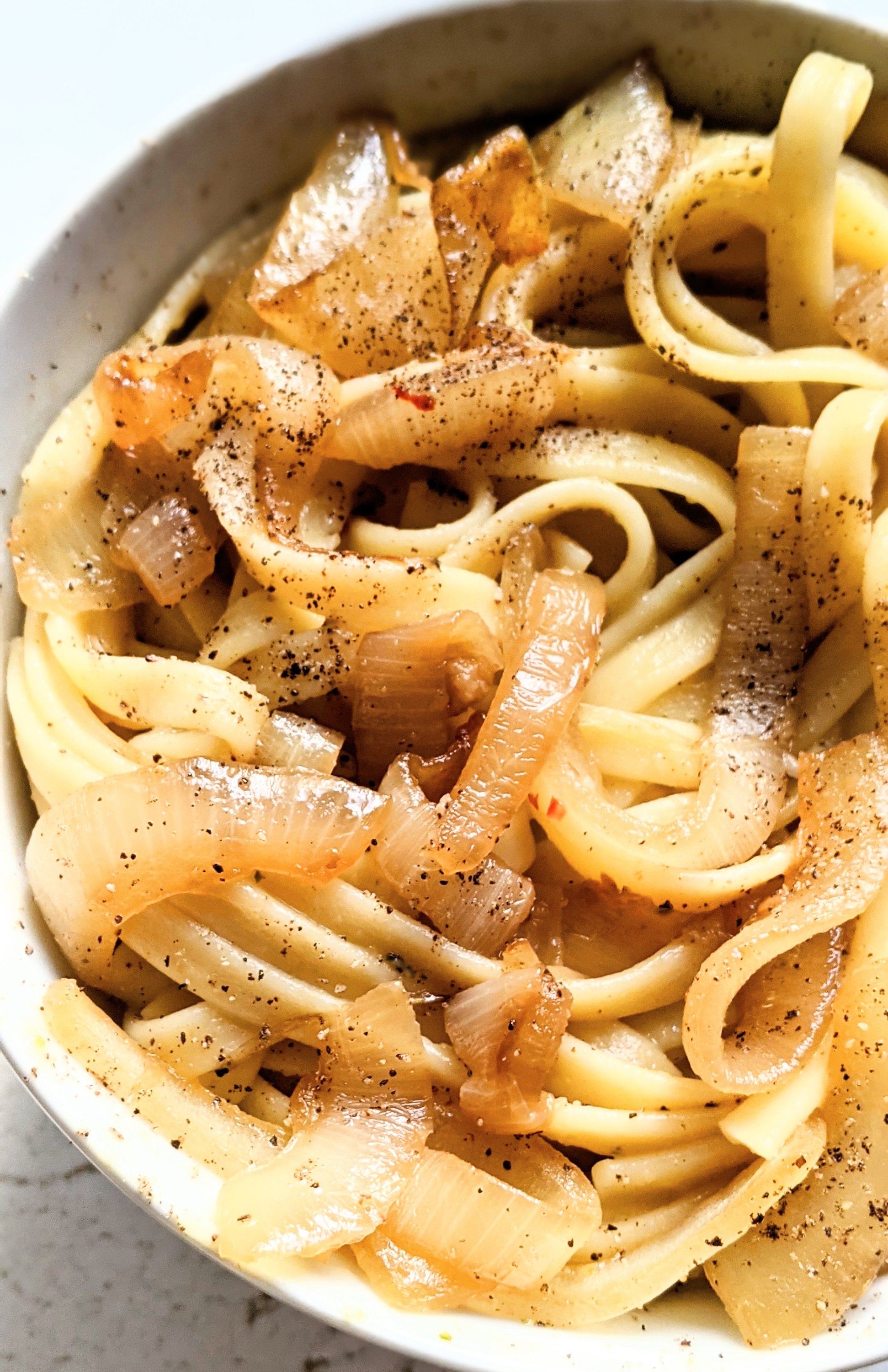 vegan onion alfredo sauce with caramelised onion pasta gluten free noodles with onions recipe with gluten free linguine or fettuccini and caramelized onions in the dutch oven