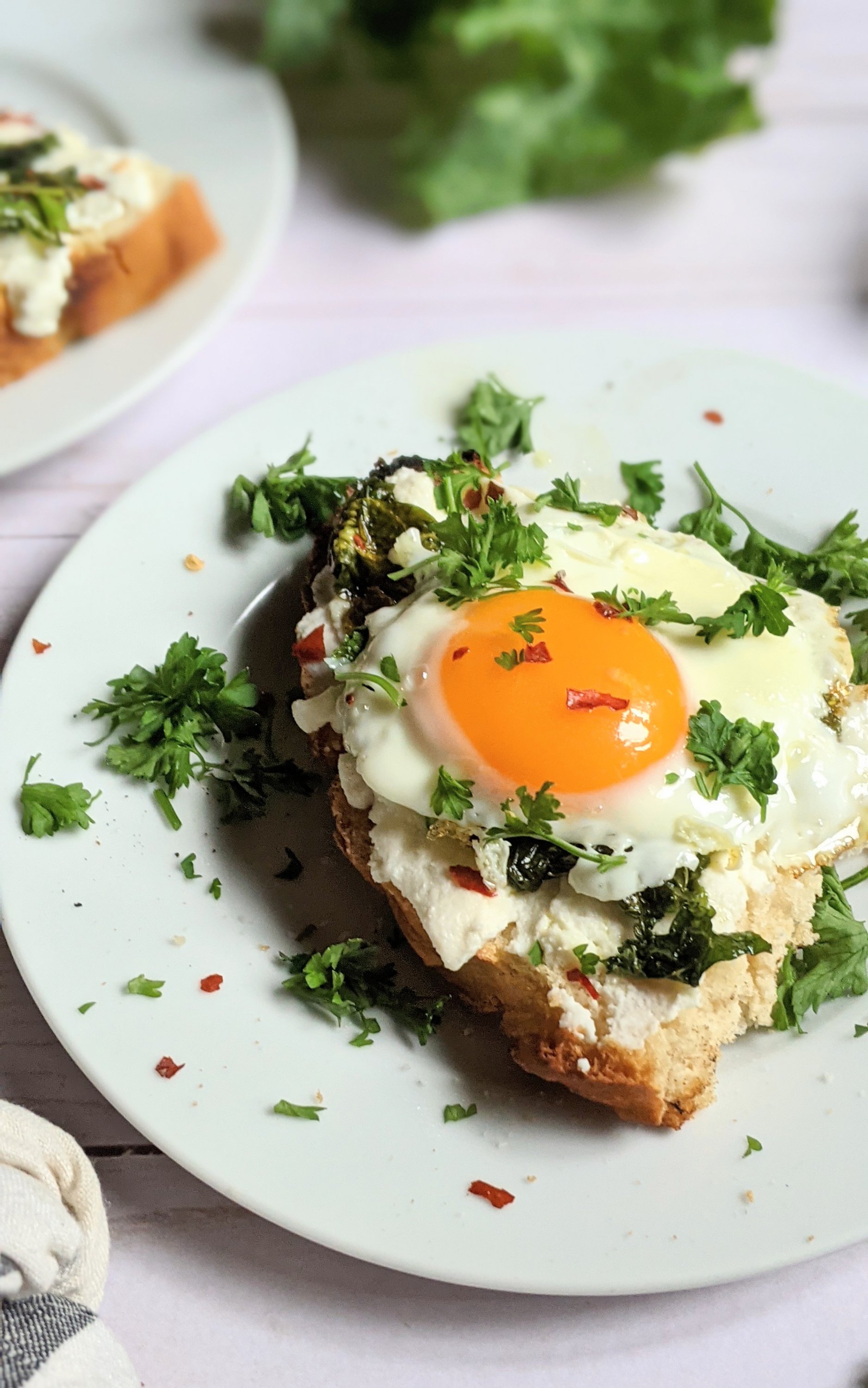 ricotta and egg toast with creamy cheese recipe gluten free bread with ricotta cheese sauteed garlic and kale a fried egg and parsley healthy breakfast high protein