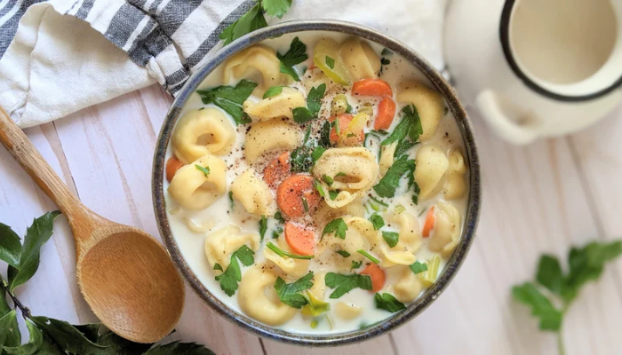 healthy tortellini soup with carrots, celery, parsley, cream and low sodium vegetable stock