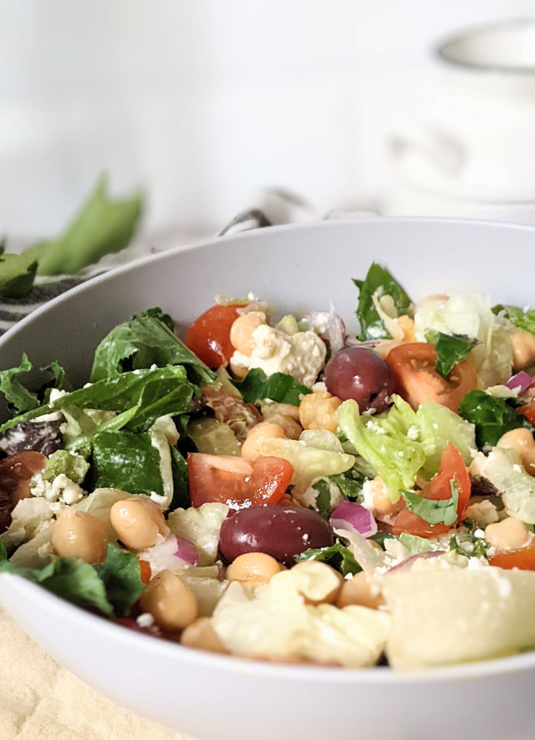 chickpea chopped salad recipe with greek olives and cucumbers healthy high protein vegan lunches with chickpeas garbanzo bean salad with greek dressing and tomatoes spinach and iceberg lettuce