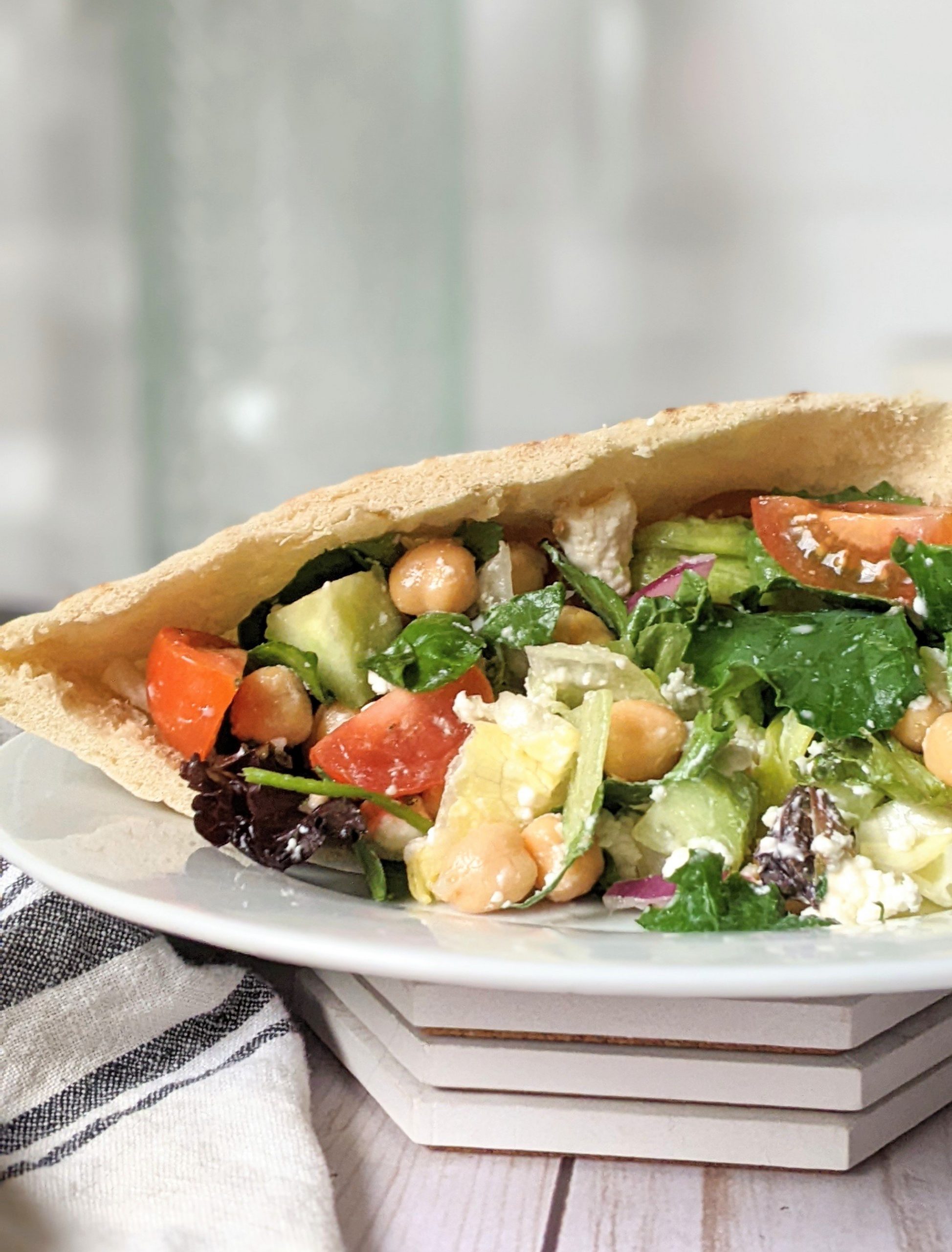 loaded greek salad pita with chickpeas hummus lettuce and tomatoes cucumber wrap in a pita pocket with garlic hummos and garbanzo beans high protein lunch ideas healthy salad wrap recipes