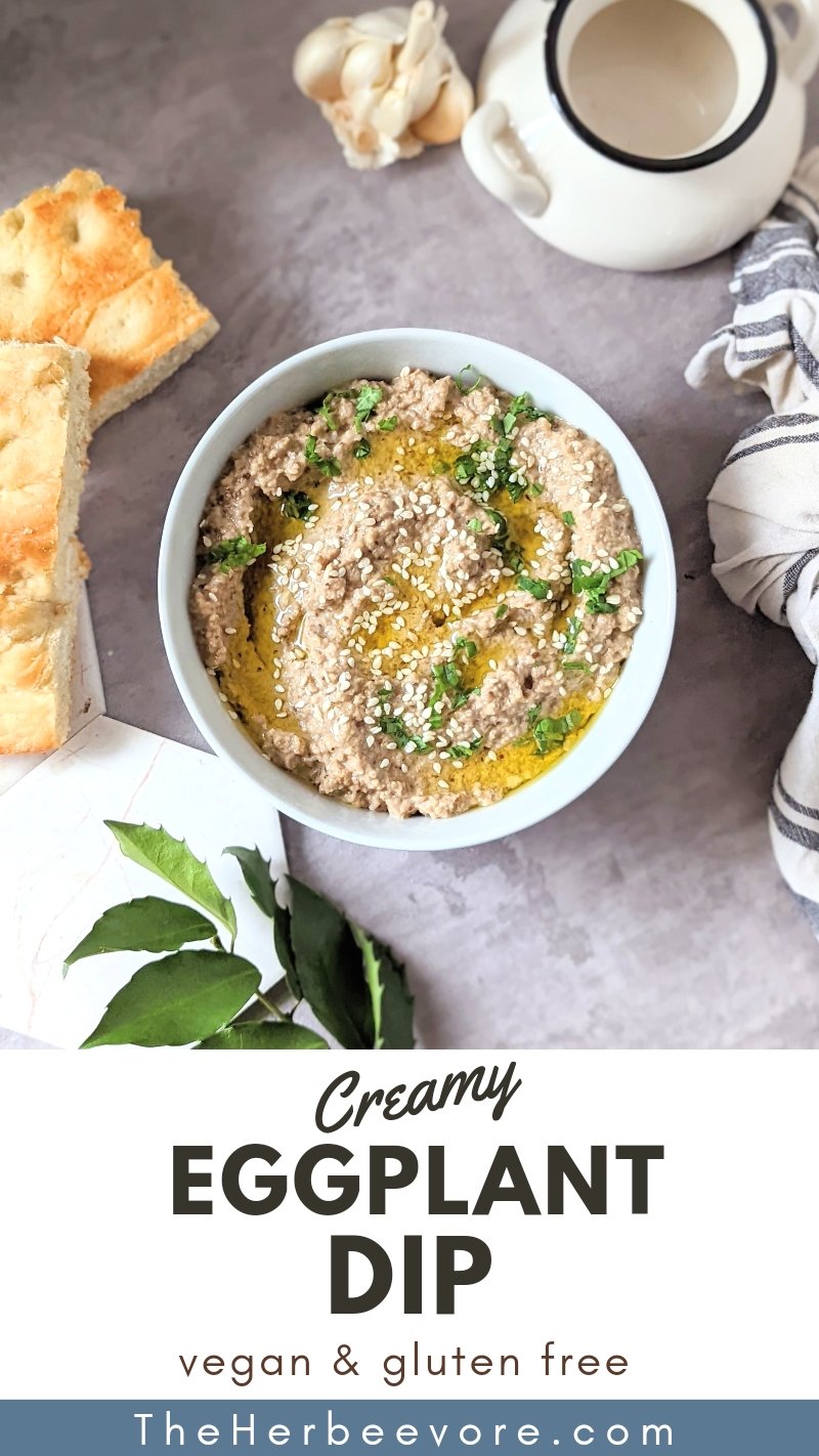 eggplant dip recipe with tahini and lemon garlic in a white bowl with greens and slices of fresh bread for dipping vegan and vegetarian appetizers.