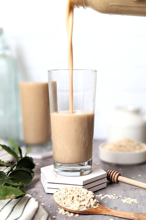 oat milk shake with vanilla protein powder frozen bananas and flaxseeds for a healthy homemade breakfast high in fiber.