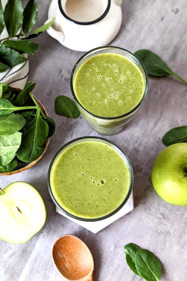 green apple smoothies with spinach banana pineapple flax seed meal and a vegan and gluten free protein powder for a healthy breakfast.