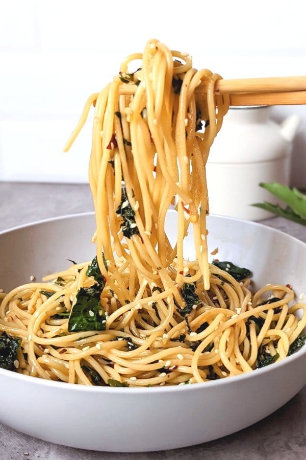work from home lunches with noodles and chili oil pasta recipe with garlic and kale lo mein with chopsticks in a bowl.