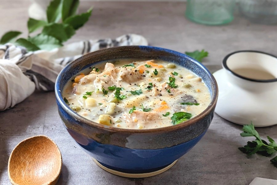 dairy free turkey stew with vegetables recipe creamy of turkey soup with coconut milk in a blue glazed bowl.