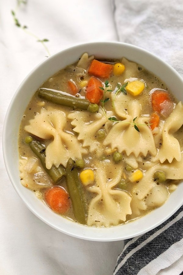 vegan pot pie soup recipe with noodles vegetables carrots corn peas green beans and farfalle bowtie pasta noodles healthy easy meal prep recipes for vegan comfort food soup winter fall dinners
