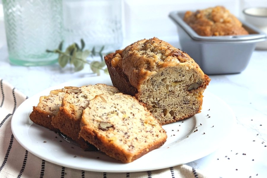 chia seed banana bread recipe easy and easy recipes for mashed bananas baking with banana in mini loaves or muffins, sliced on a plate with a mini loaf of banana bread in the background.