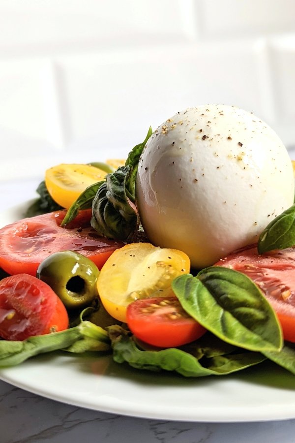 burrata caprese salad with tomatoes basil olive oil and balsamic vinaigrette and Castelvetrano olives salad recipes for summer cookout appetizers