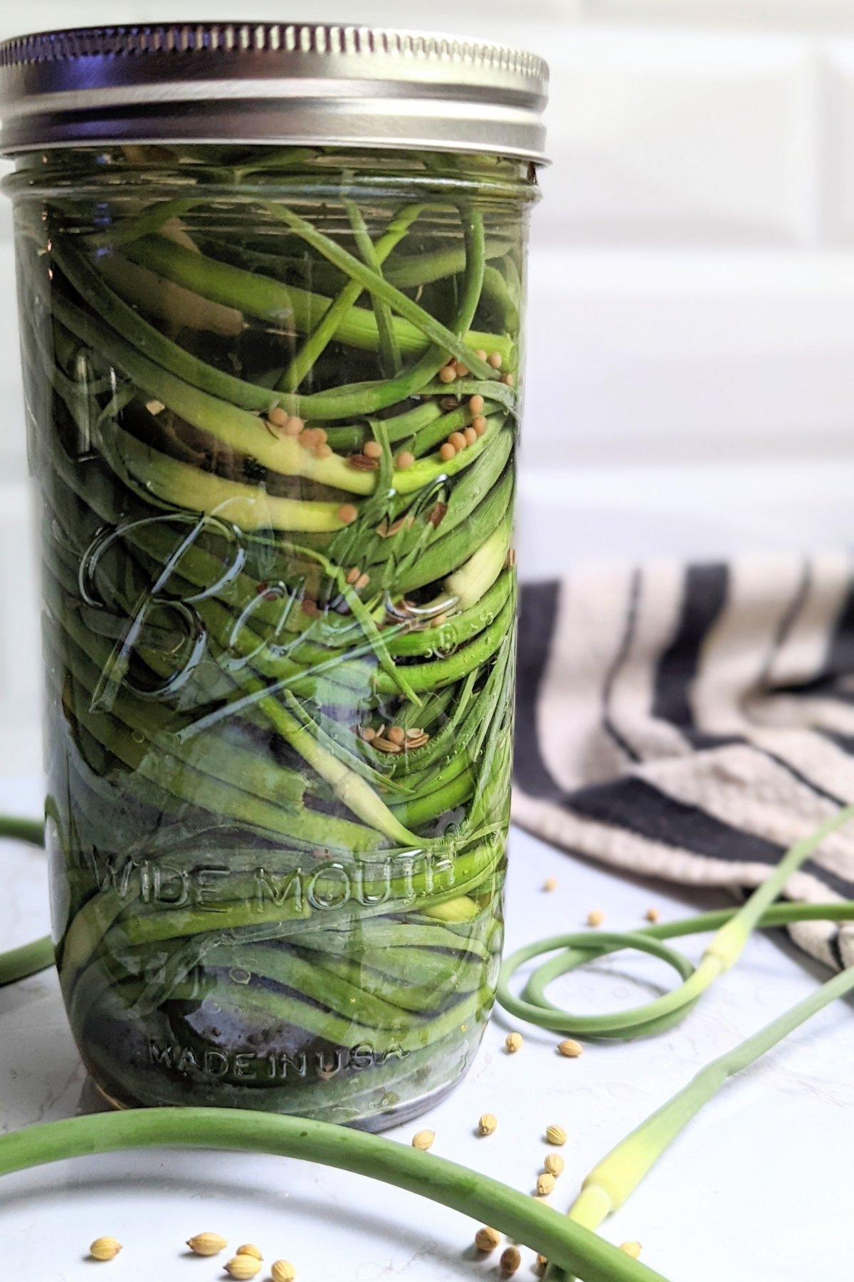 garlic scape recipes with pickled scapes in vinegar sugar dill garlic mustard seed fennel seed and chili peppers