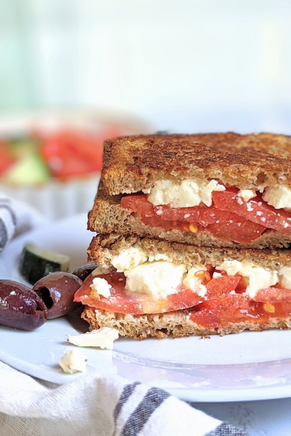 grilled feta cheese sandwich with feta recipes toasted feta cheese sandwich with tomatoes kalamata olives and cucumber salad in the background