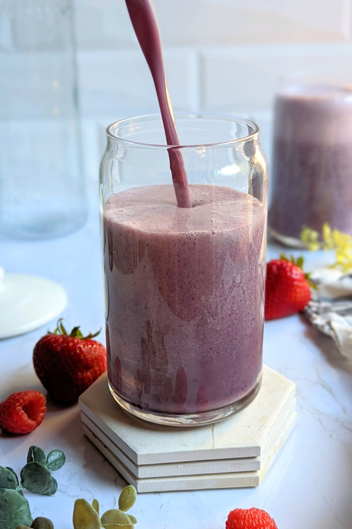 raspberry protein smoothie with vegan protein powder vanilla banana strawberries and blueberries healthy high fiber and high protein vegan breakfast ideas
