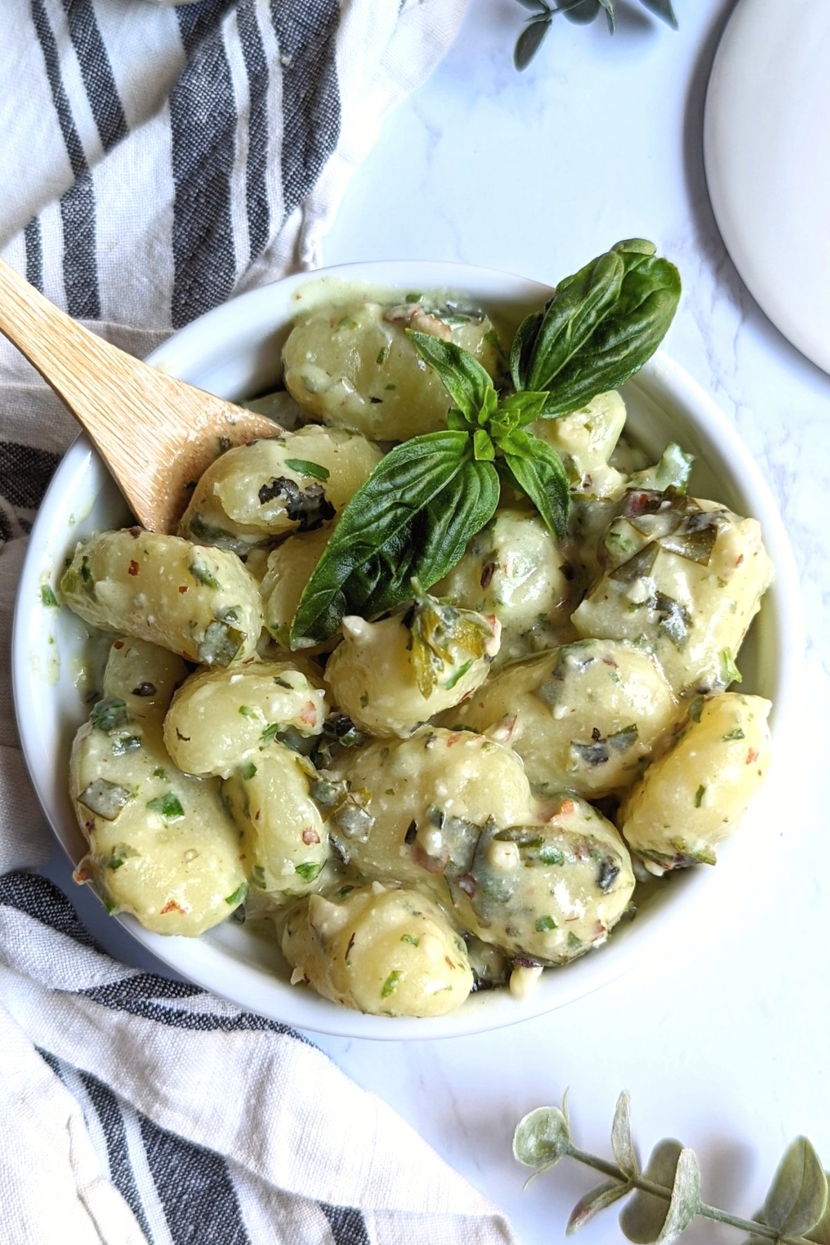 creamy gnocchi with pesto made with basil garlic olive oil water walnuts in a food processor and lemon juice