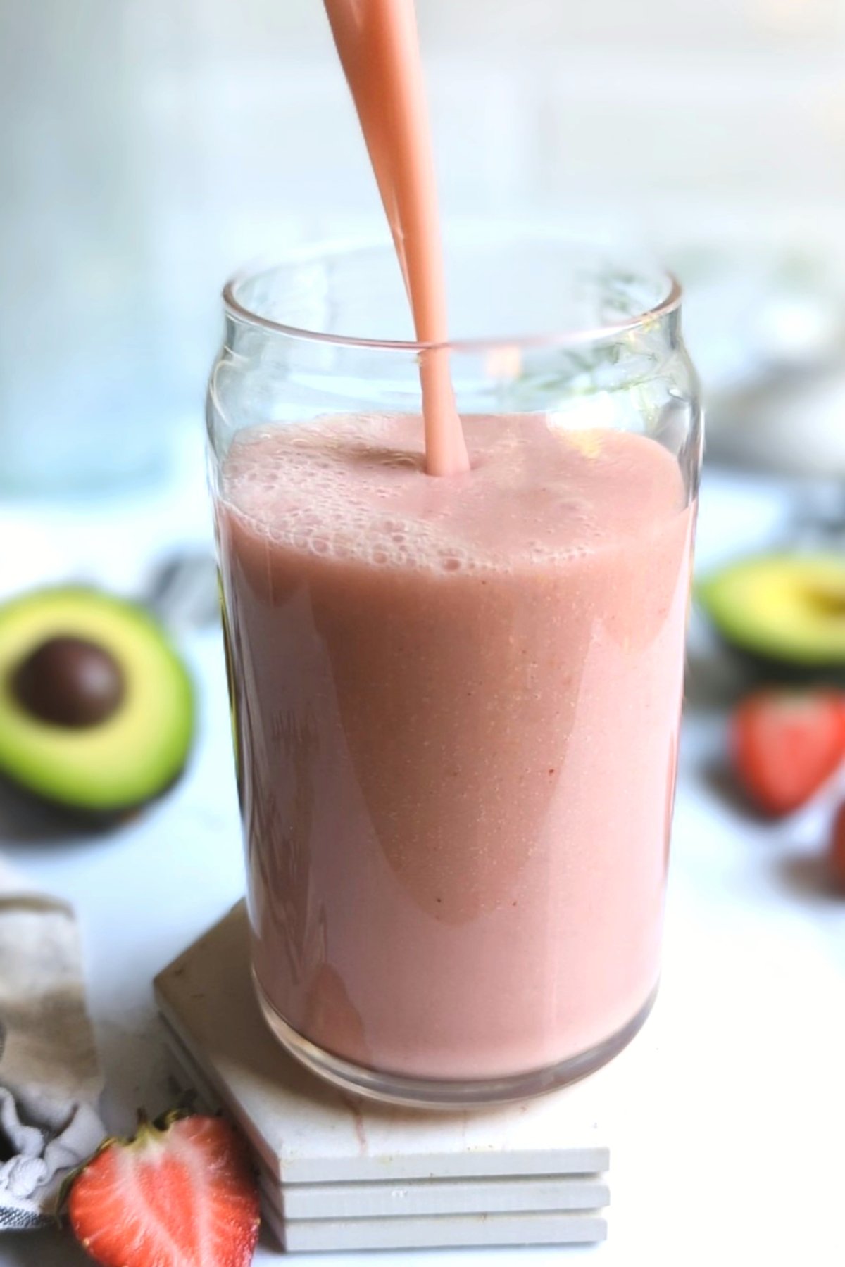 avocado smoothie with strawberries and avocadoes blended together poured into a trendy can shaped glass vegan gluten free high protein no whey