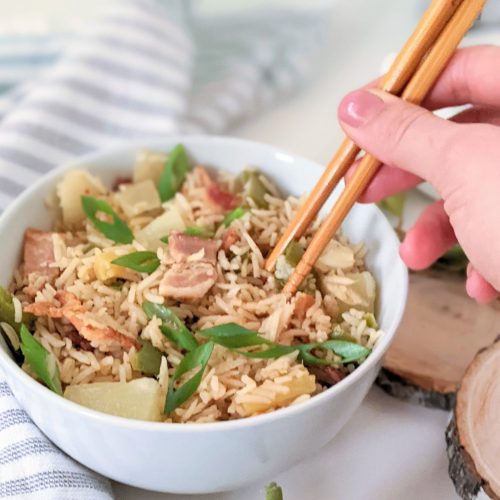 fried rice without soy sauce recipe a hand holding chopsticks and eating fried rice no soy