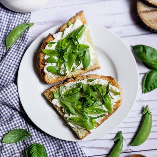 garlic toast with snap pea ricotta toasts on a plate with basil and fresh snap pea recipes