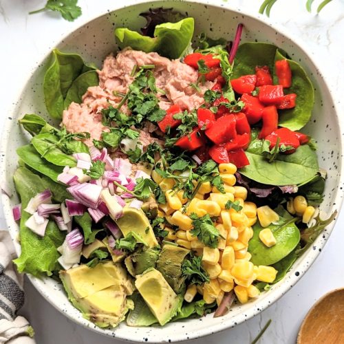 tuna taco salad recipe with avocado corn bell peppers onions and a lime dressing high protein low carb