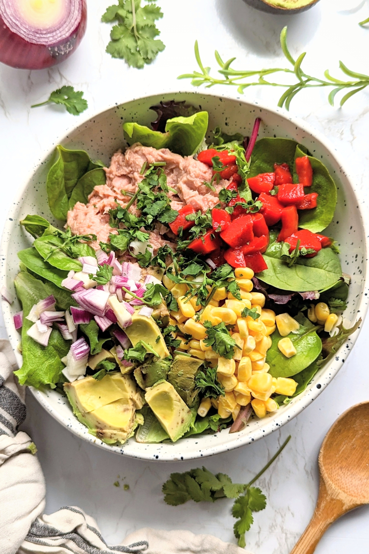 tuna taco salad recipe with avocado corn bell peppers onions and a lime dressing high protein low carb