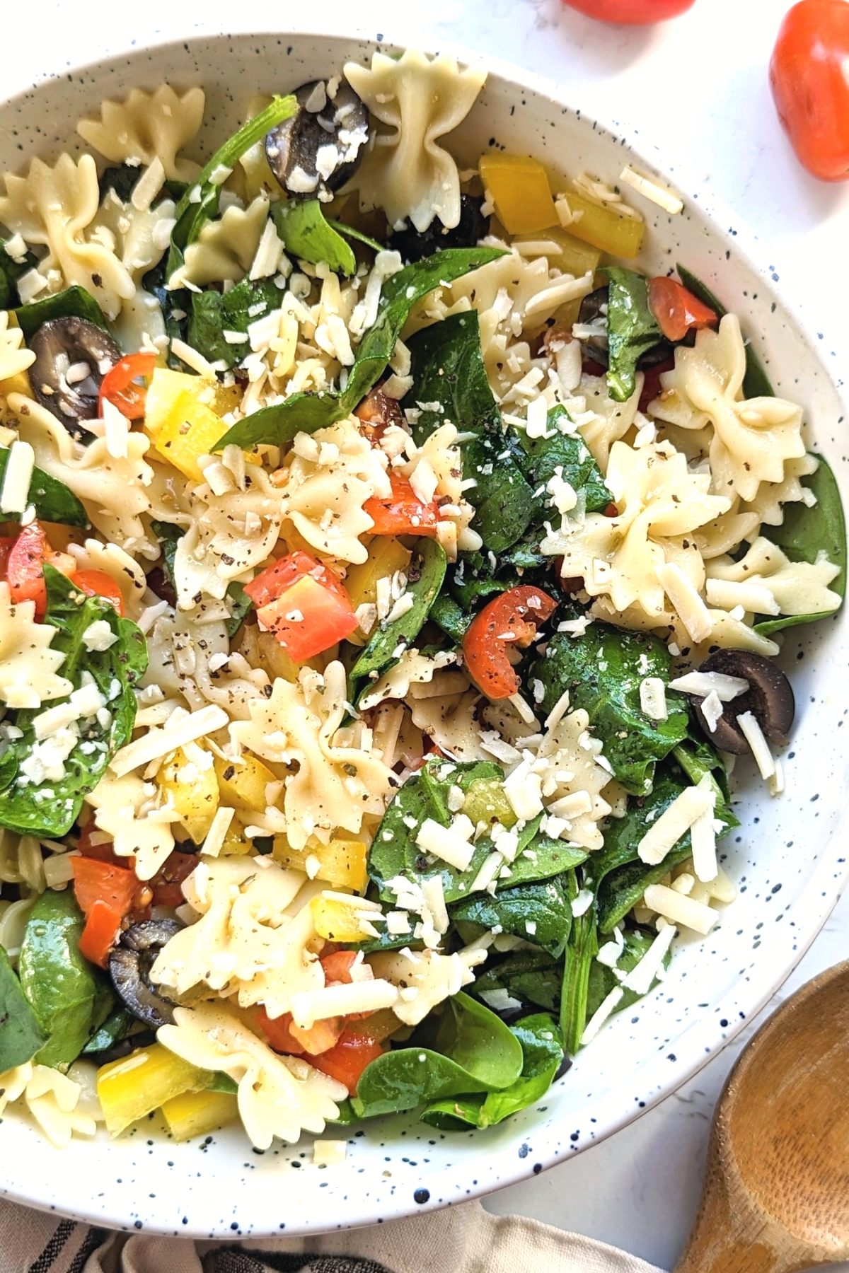 bowtie pasta salad recipe with spinach parmesan cheese tomatoes and bell pepper with a vegan option for farfalle pasta salad 