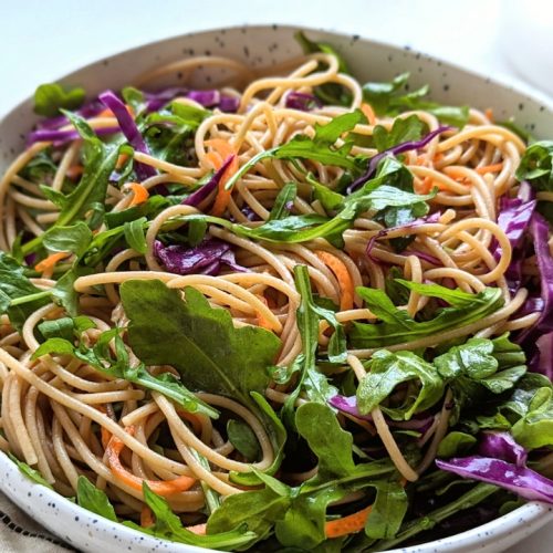 arugula noodle salad recipe with carrots red cabbage and a sweet honey lime sesame dressing