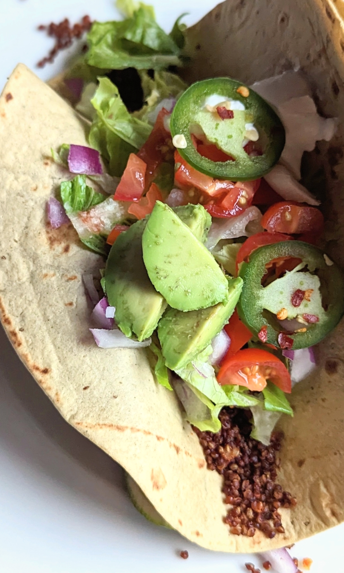quinoa taco meat with onions jalapeno peppers tomato avocado and sour cream vegan taco filling