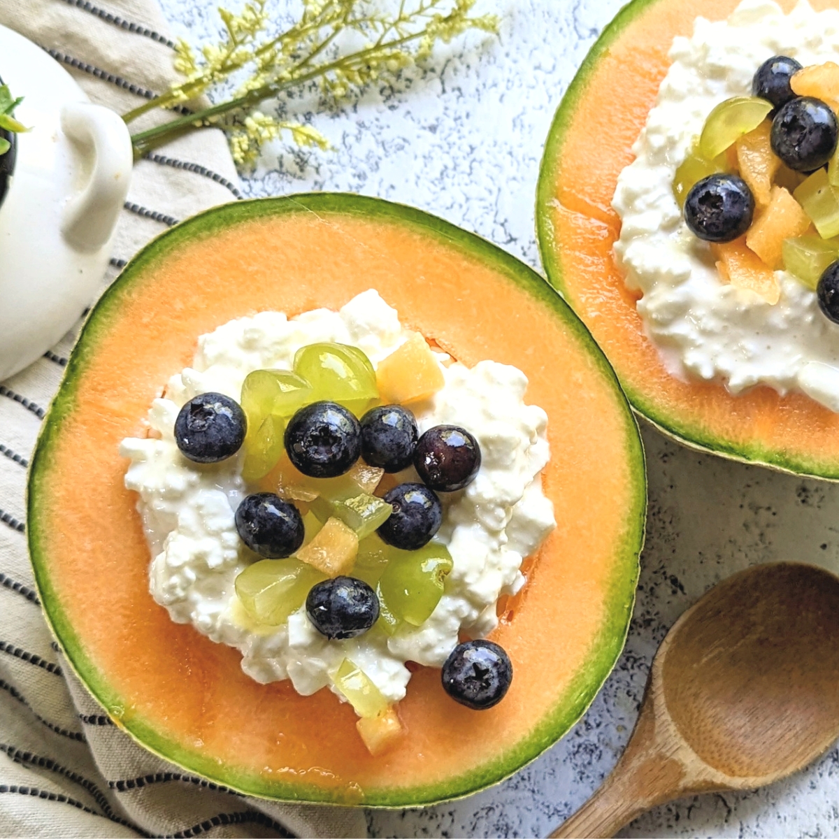 cottage cheese fruit recipes cantaloupe and cottage cheese breakfast ideas with berries and grapes in an edible bowl.