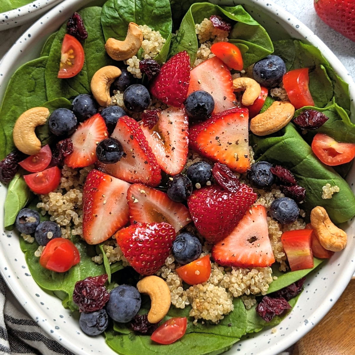summer strawberry salad with blueberry cashew nuts tomatoes and quinoa sweet and savory salad recipes with fruit