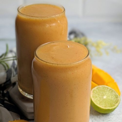 papaya smoothie recipe with mango lime juice and banana in two glasses for a healthy breakfast idea that is raw vegan