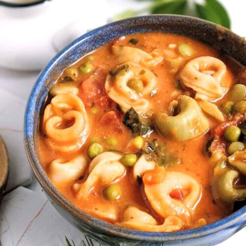 tomato tortellini soup with spinach peas carrots diced tomatoes and a creamy broth