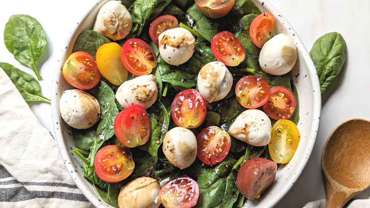 spinach caprese salad recipe with fresh tomatoes basil and black pepper