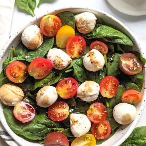 mozzarella spinach salad with cherry tomatoes balsamic vinegar olive oil and black pepper