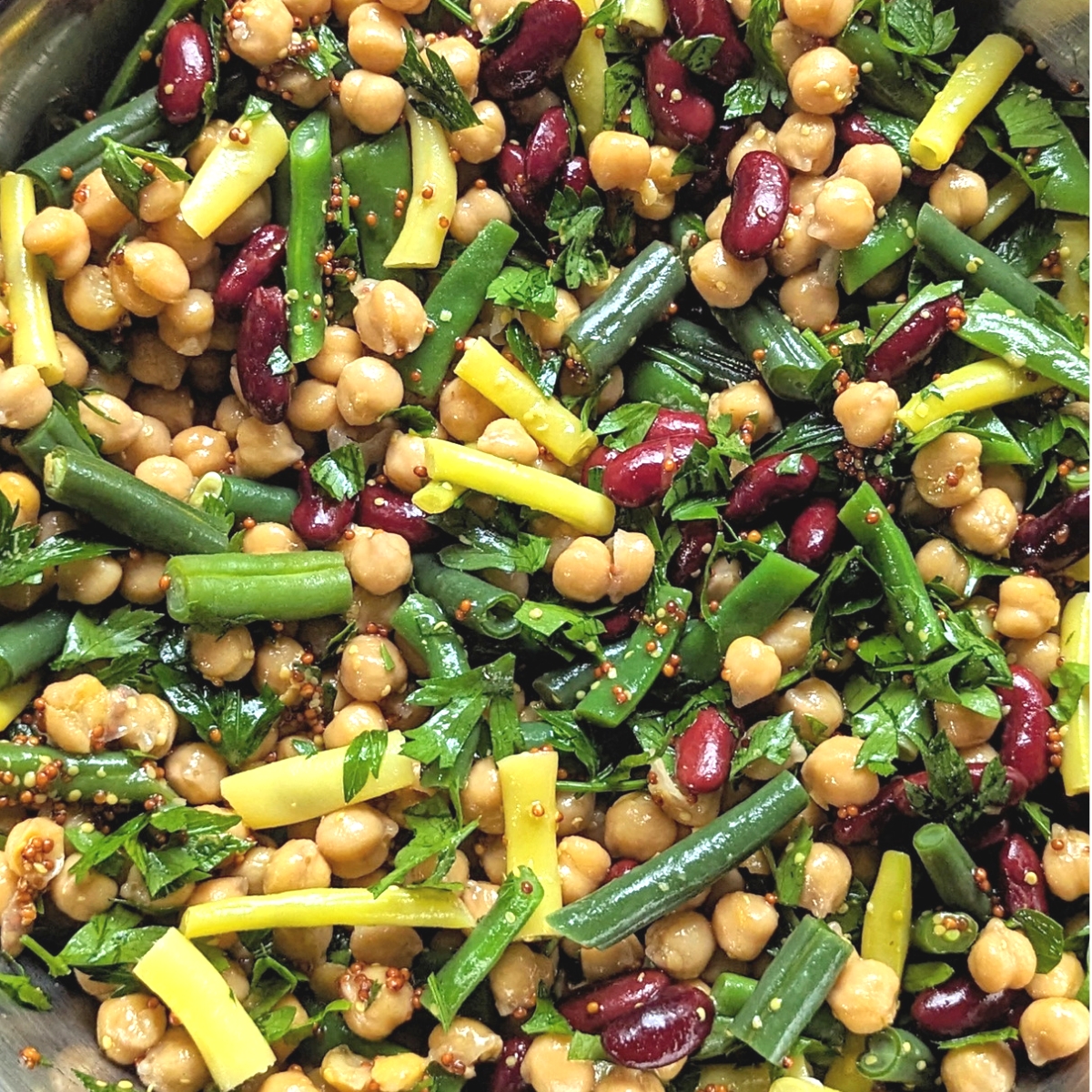 four bean salad recipe with fresh green beans yellow beans and garbanzos and kidneys in a homemade apple cider italian vinaigrette