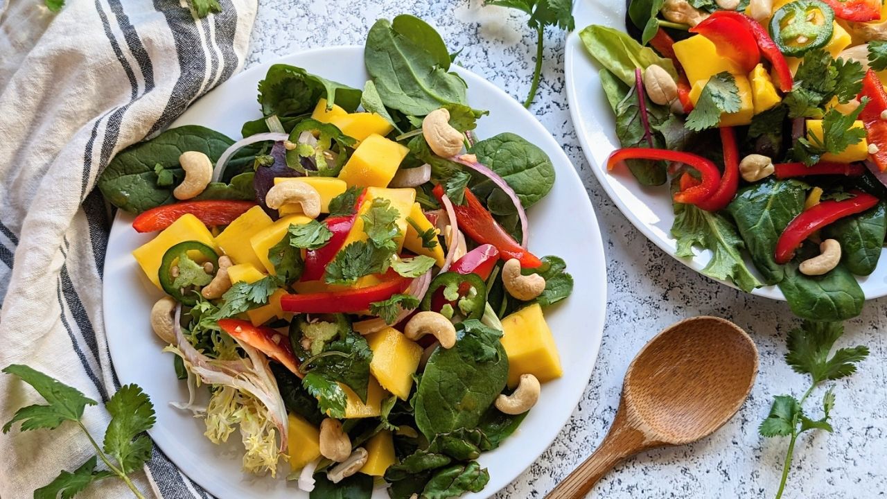 ripe mango salad yellow mangoes with sliced onions and cilantro on two plates vegetarian salad ideas