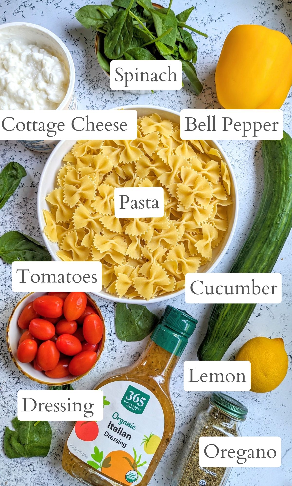 cottage cheese pasta salad ingredients like bowtie pasta tomatoes italian dressing lemon cucumber and bell peppers.