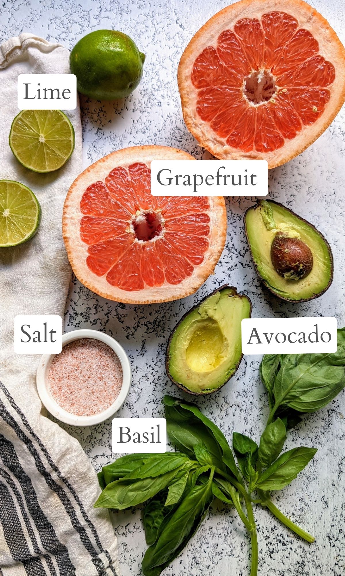 Ingredients for this salad: ruby red grapefruit, fresh avocado, limes, basil, and pink salt.