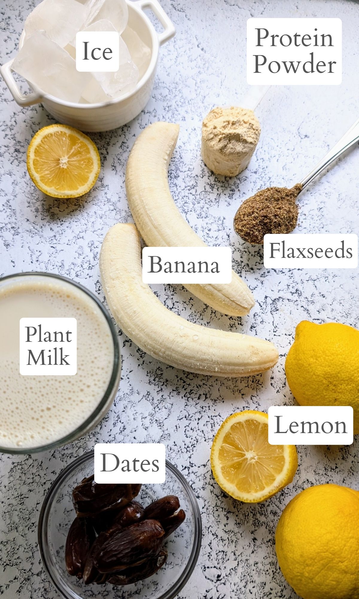 lemon smoothie ingredients like plant based milk bananas, fresh whole lemons, flaxseeds, dates, and vanilla protein powder.
