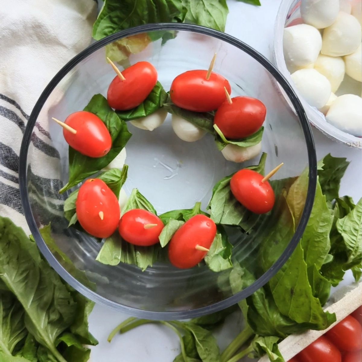 mini caprese skewers in a dish for a party.