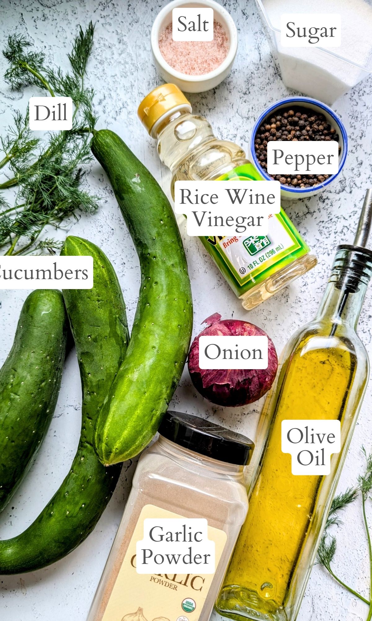 ingredients for old fashioned cucumber salad with dill onions olive oil rice wine vinegar and sugar.