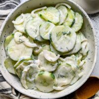 sour cream cucumber salad recipe with dill and onions and sugar.