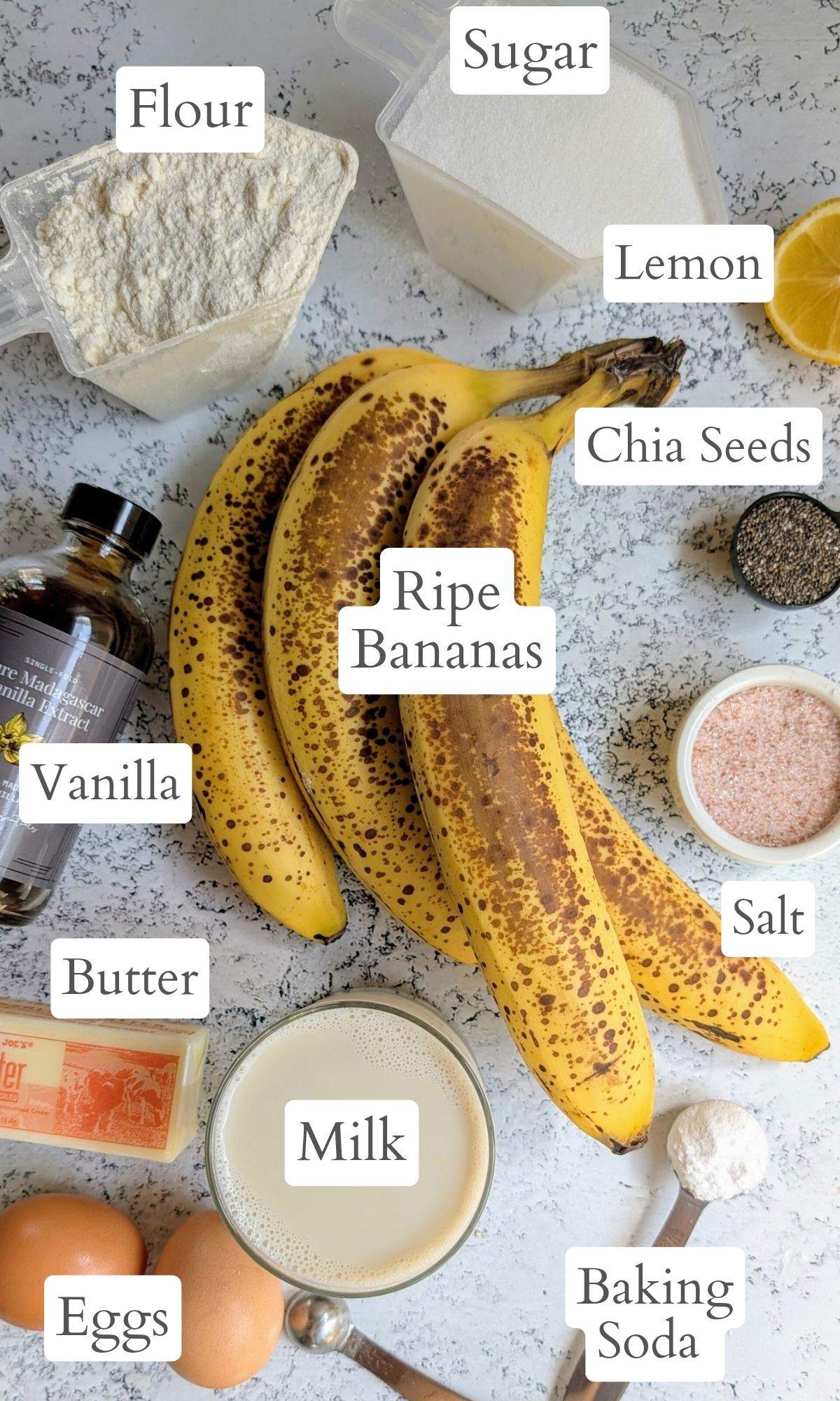 ingredients for chia seed banana bread with ripe bananas baking powder butter milk and vanilla extract.