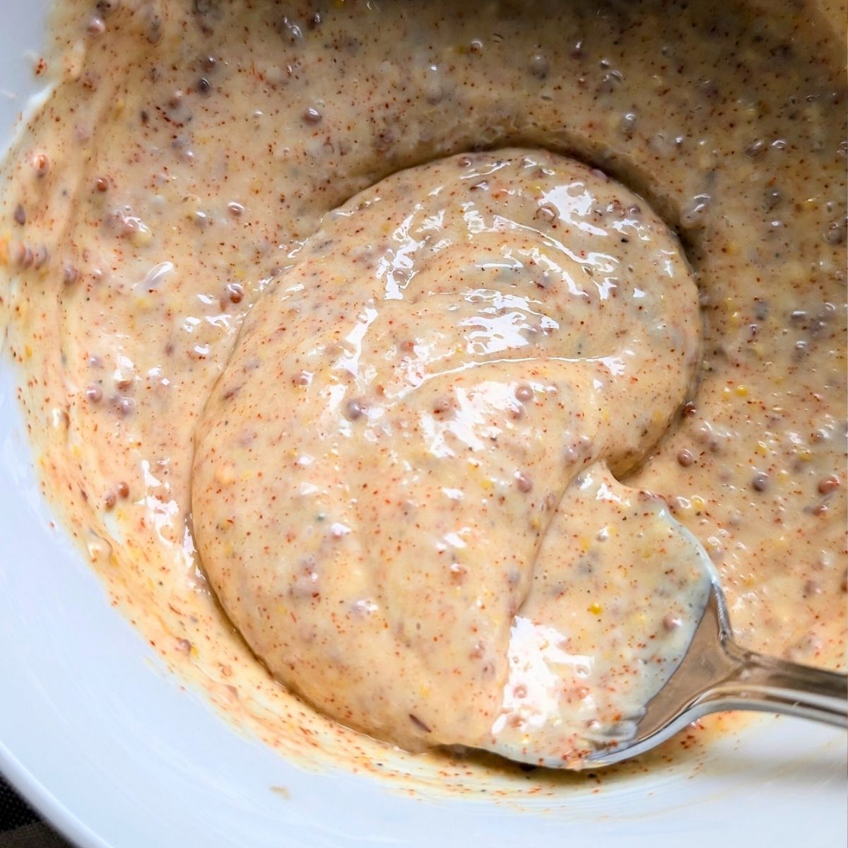 fried chicken sandwich sauce being stirred in a bowl like a copycat chick fil a or popeyes sauce.