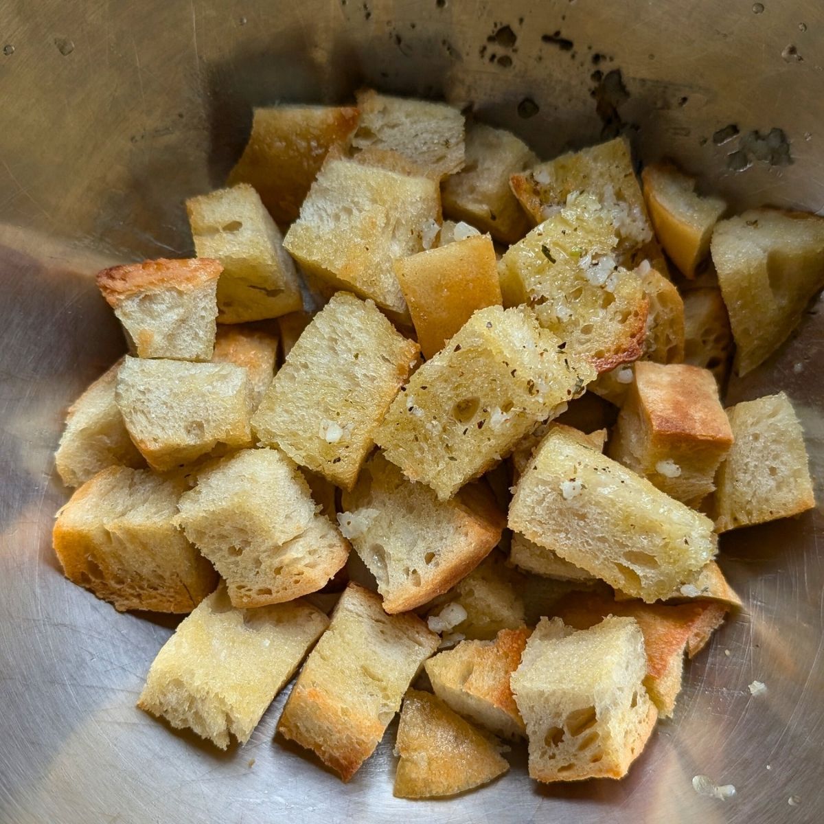 toasted sourdough croutons in a large bowl to make panzanella.