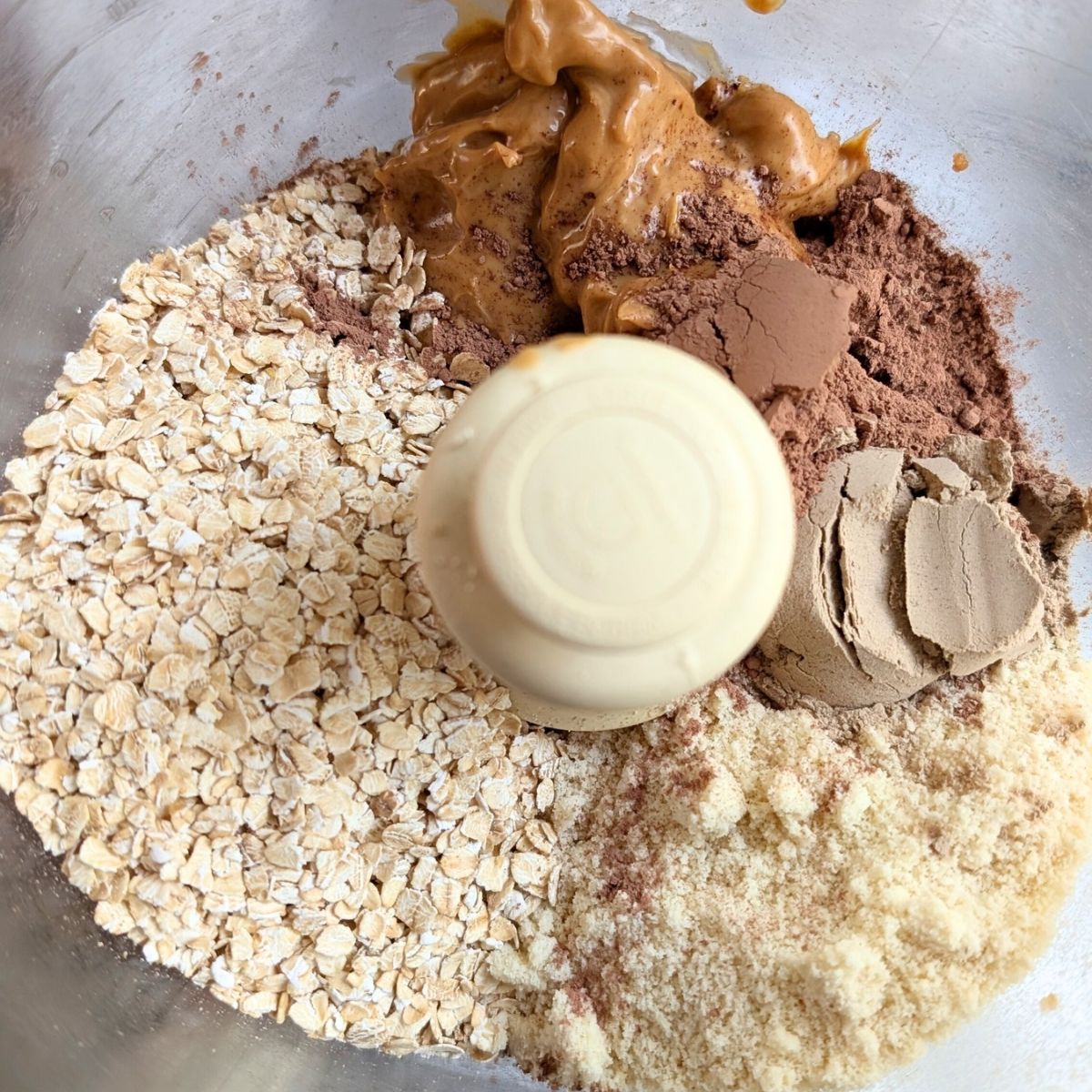 oats, peanut butter, chocolate, and protein powder, and almond flour in a food processor.