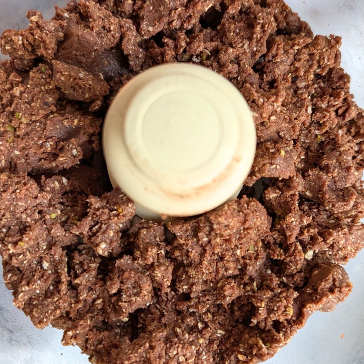 making oat balls in a food processor with oats, maple syrup and naturally sweet snacks.