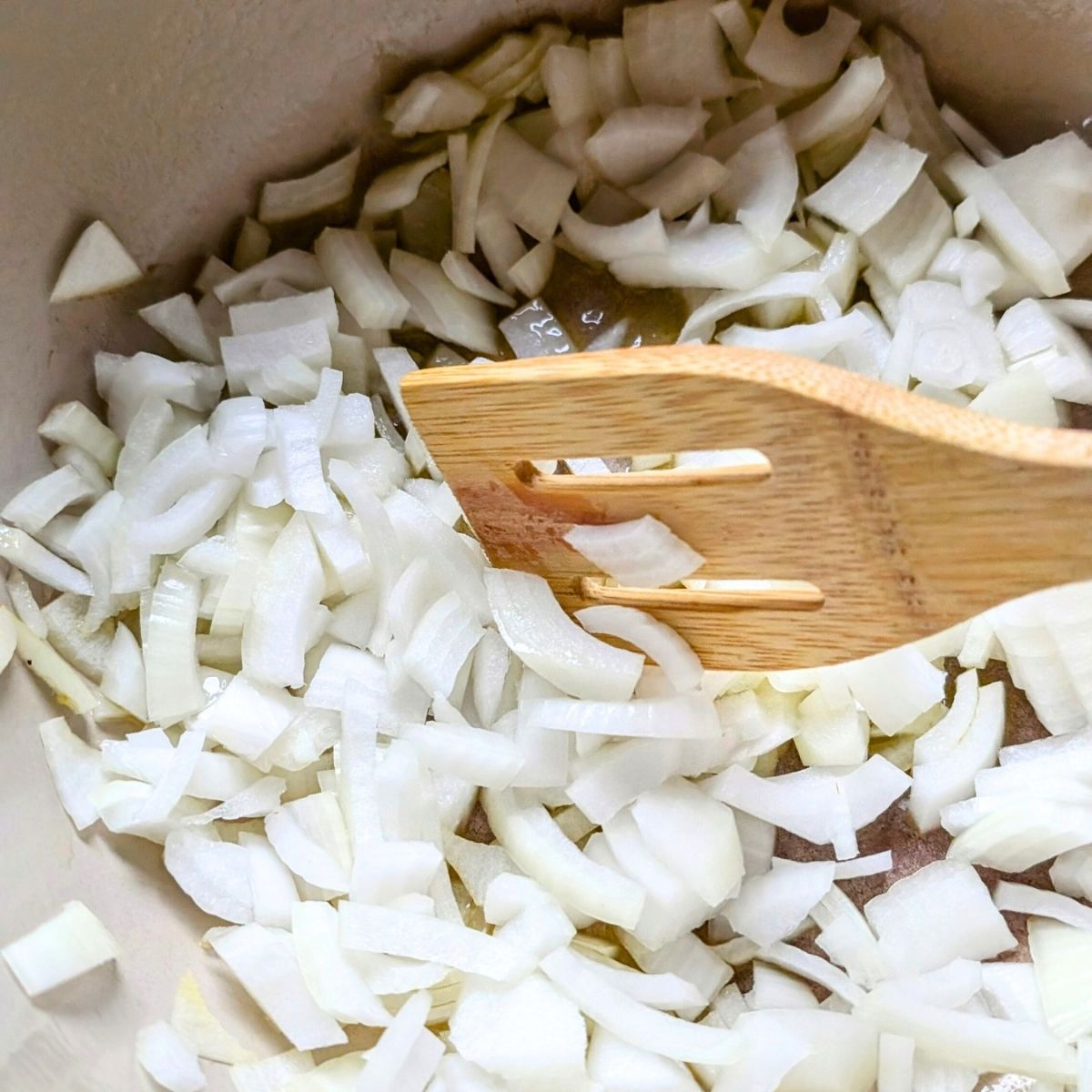 a pot with sauteeing onions and garlic with a little olive oil as a pasta sauce base.