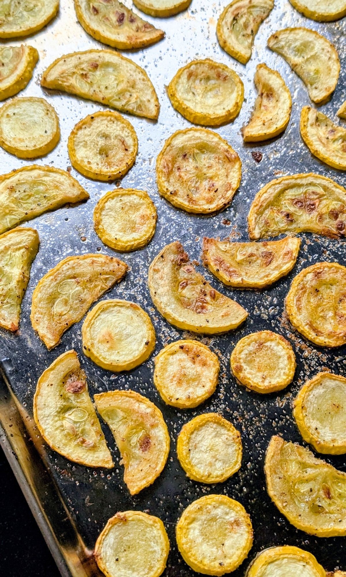 a sheet pan of roast crookneck squash baked until golden brown.